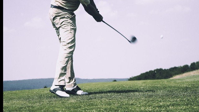 Older man enjoying golf swing on sunny course, TPI Certification in Towson MD.