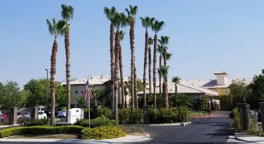 Commercial palm tree planting and landscape maintenance at gated community entrance by Beaver Brothers Tree Service in Las Vegas.