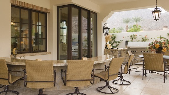 outdoor kitchen with seating around circular bar