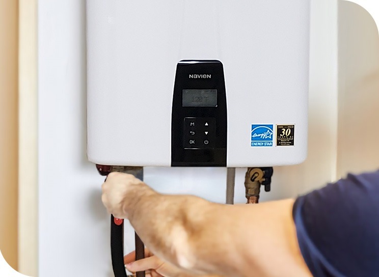 houser's air conditioning & heating service technician installing tankless water heater in iowa
