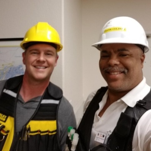 2 men in hard-hats smiling