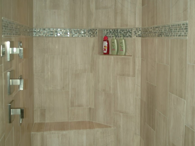 Granite shower with shampoo on a shelf