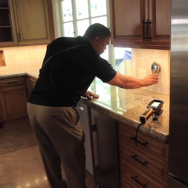 Frank Colbert conduction lead testing service in a kitchen