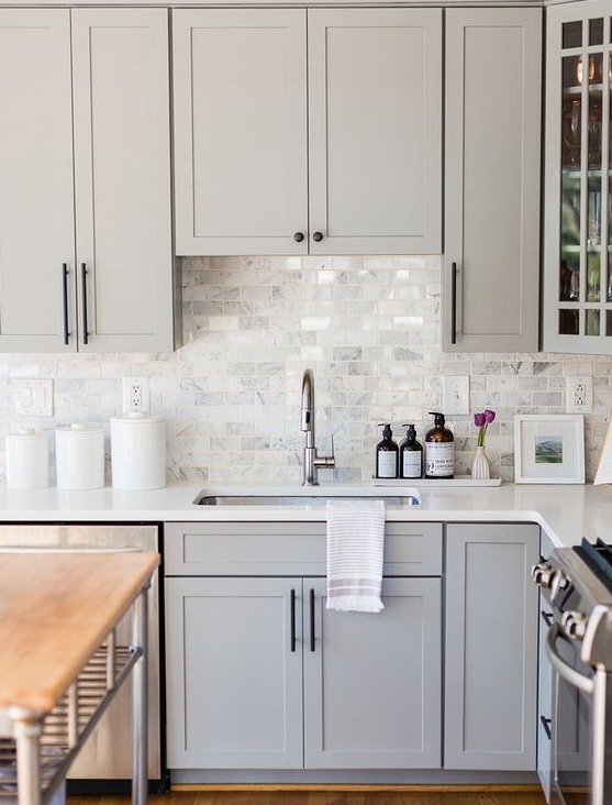 white kitchen cabinets with a wood island
