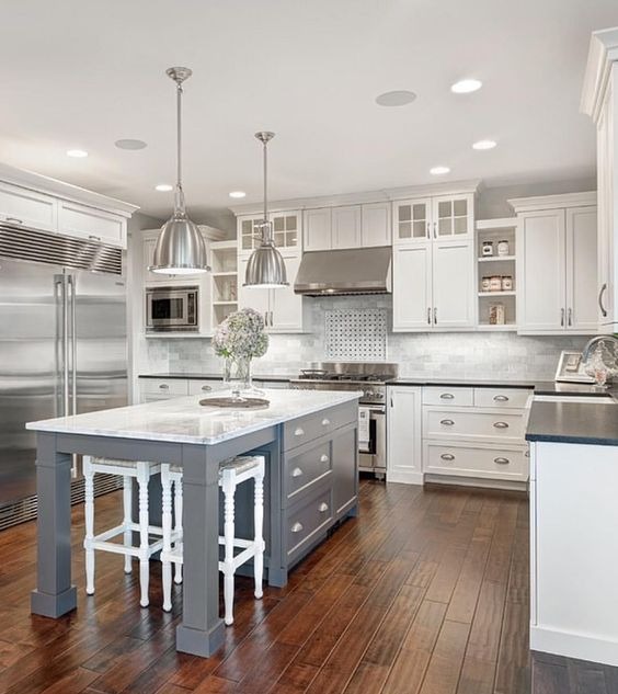 modern kitchen with island and white cabinets and dark wood floor