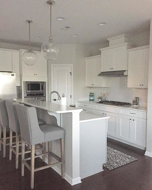 white kitchen cabinets with a wood island