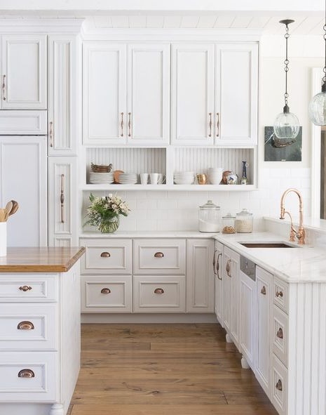 modern kitchen with island and white cabinets and dark wood floor