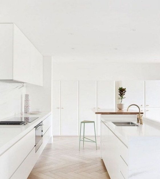 white kitchen cabinets with a wood island