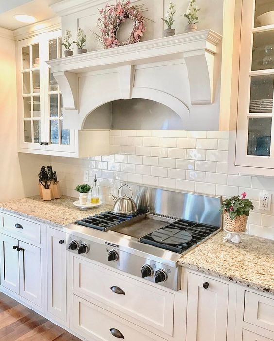 white kitchen cabinets with a wood island