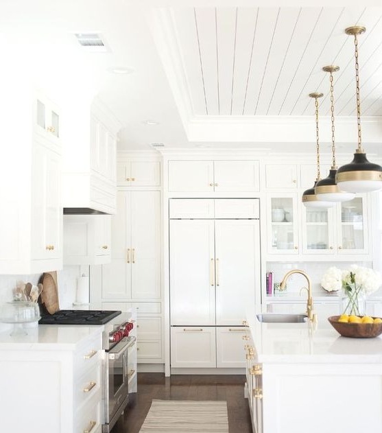 modern kitchen with island and white cabinets and dark wood floor