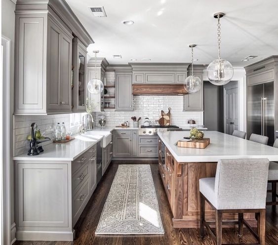 white kitchen cabinets with a wood island