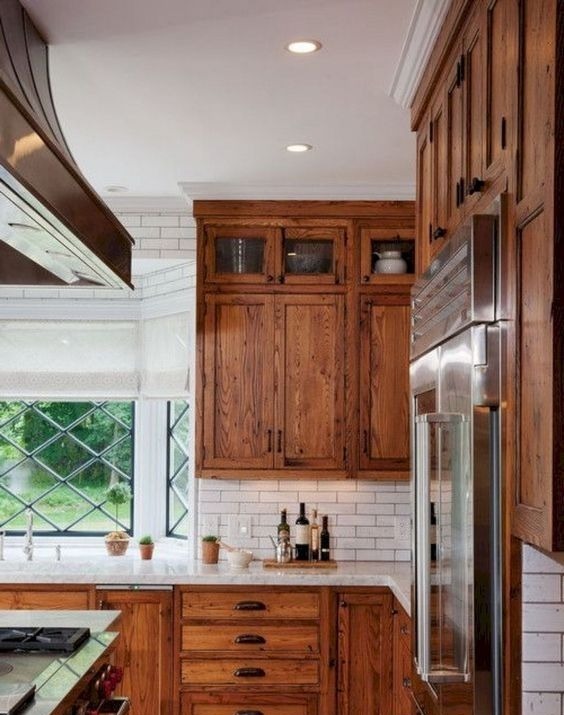 modern kitchen with island and white cabinets and dark wood floor