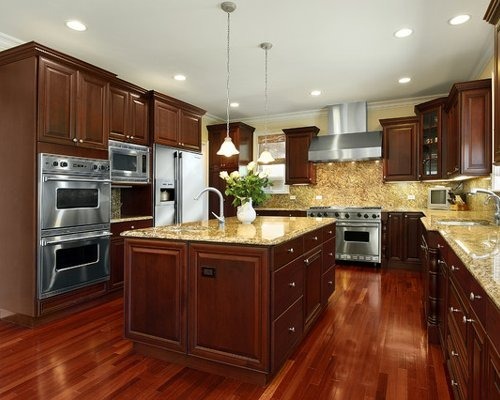 modern kitchen with island and white cabinets and dark wood floor