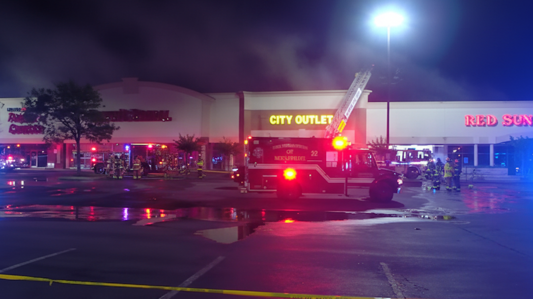 Firefighters battling urban blaze, showcasing community support in fire safety.