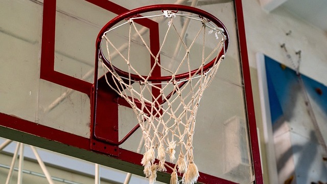 Razorbacks Recruitment banner held by two players on court.