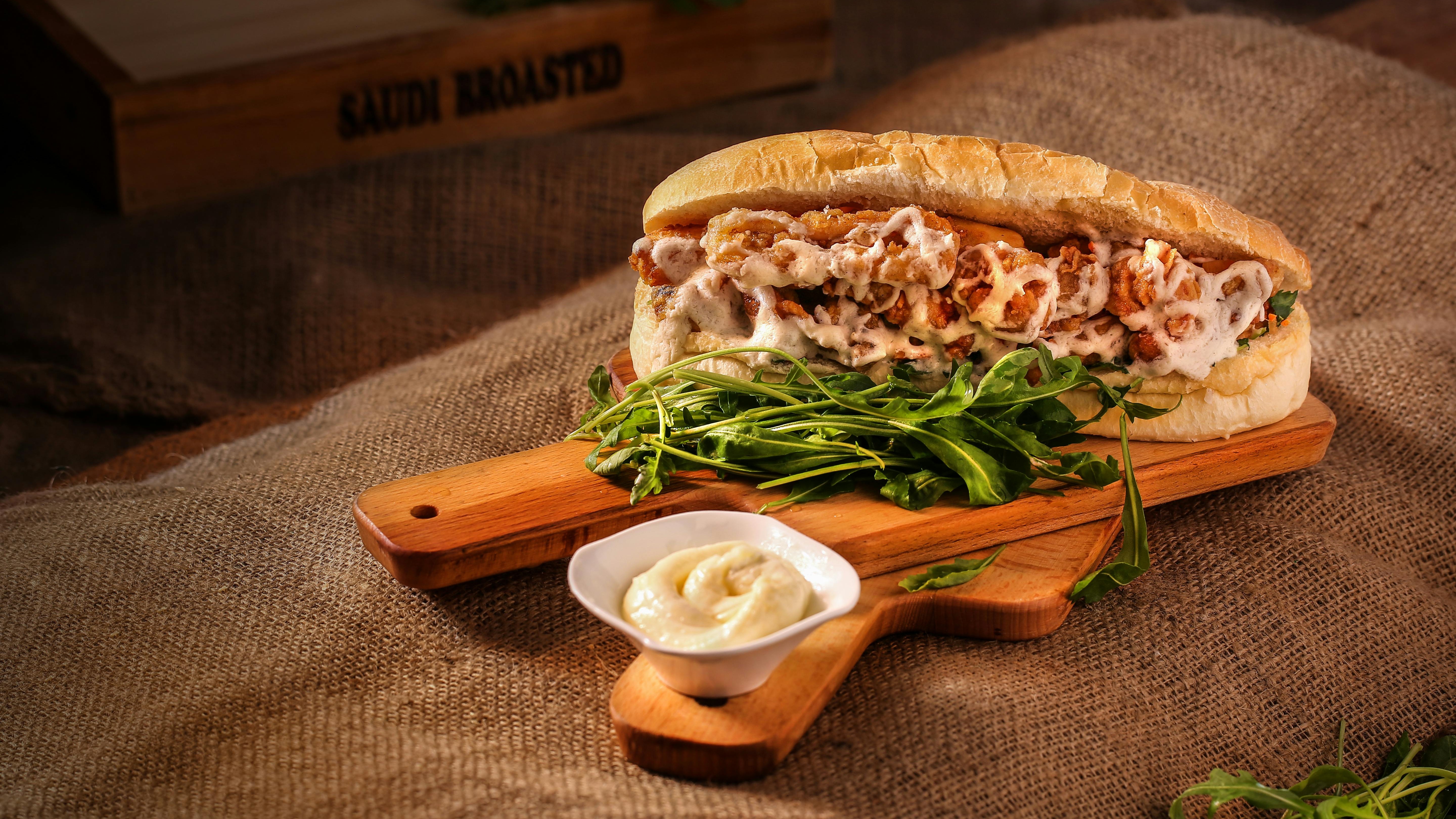 Vibrant image featuring surprised person and sandwich with Yelp 100 text.