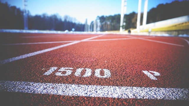 Arkansas women's track and field hurdles aligned on a track.
