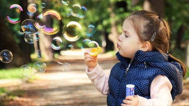 kid enjoy vibrant local businesses at a sunny outdoor festival in Fayetteville.