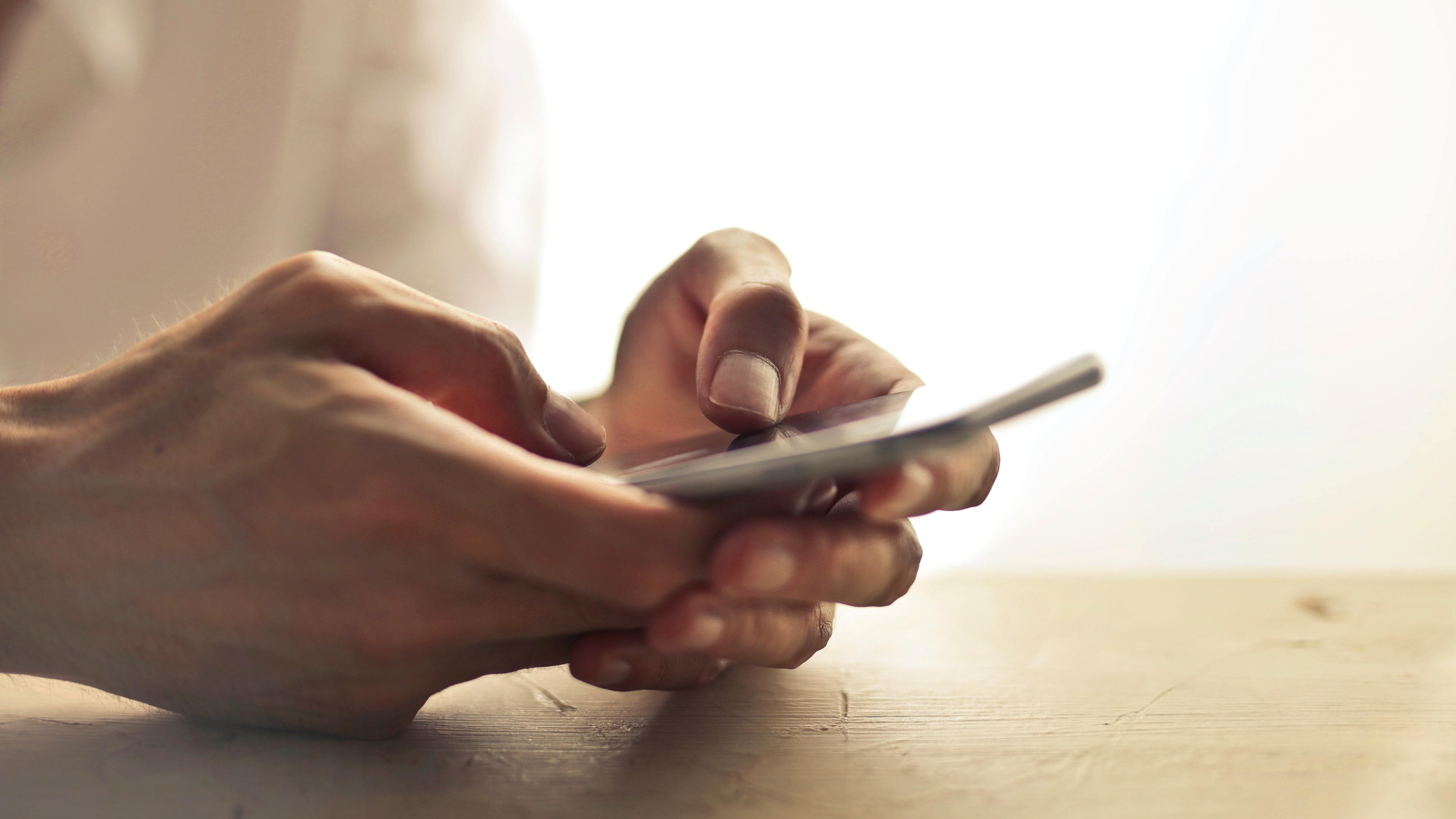 Arkansas Mobile ID displayed on smartphone in hand.