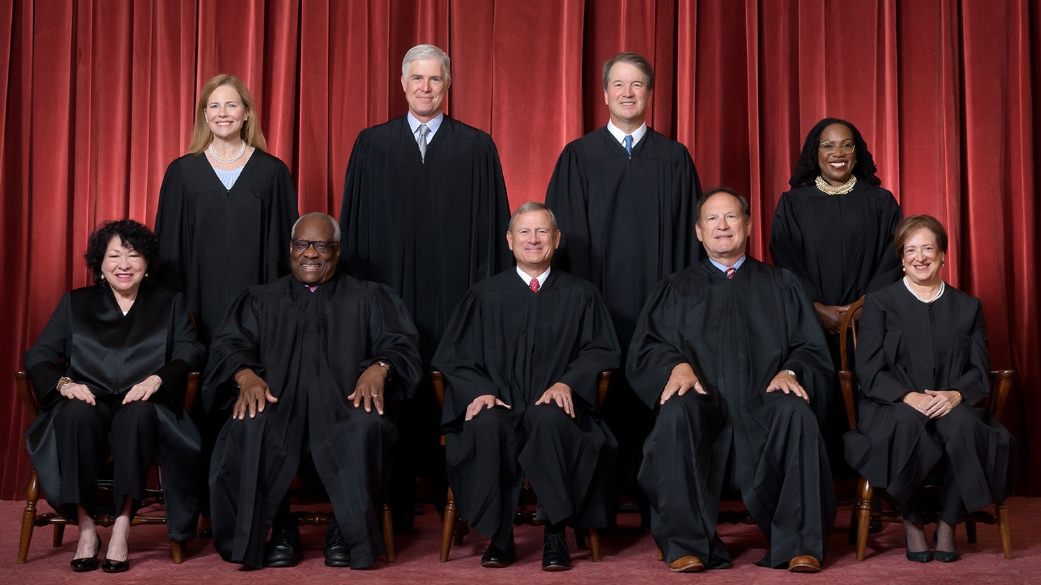 Supreme Court building under cloudy sky for birthright citizenship ruling.
