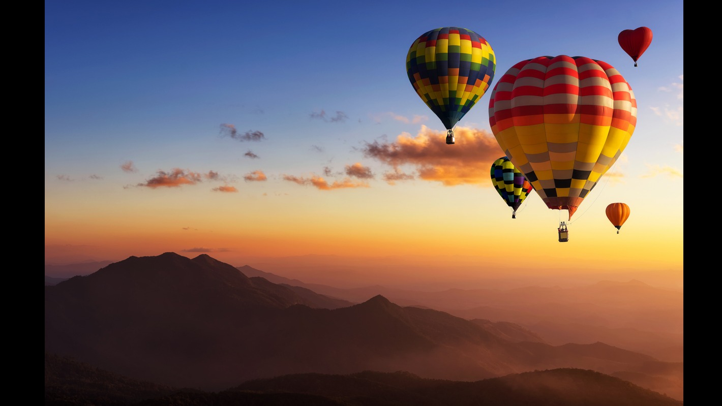 Hot air balloons in flight in the skies over Bentonville, AR.
