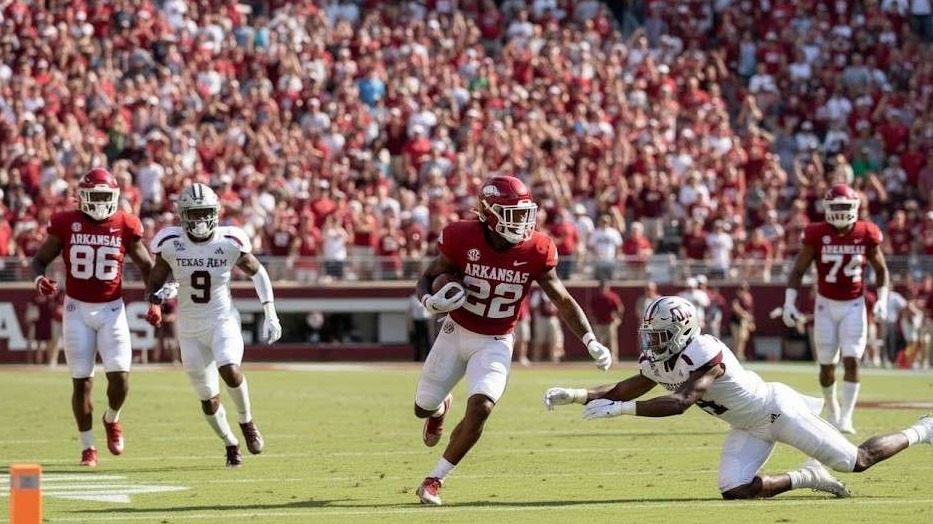 Texas A&M vs. Arkansas game at full stadium, night excitement