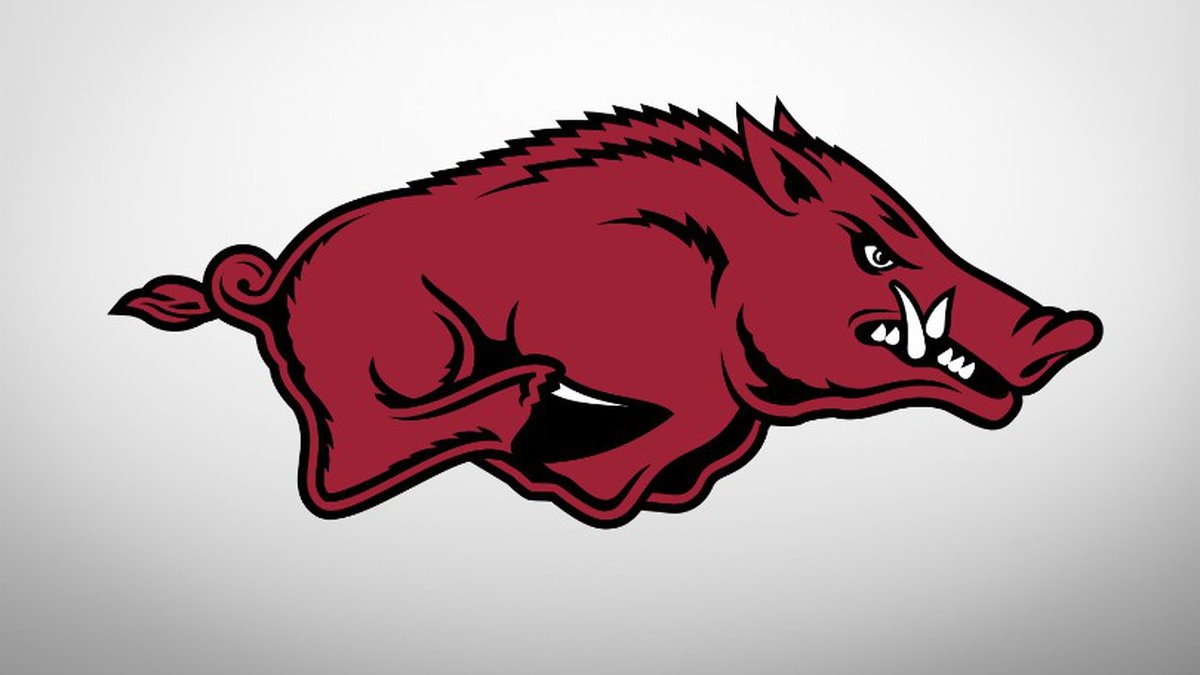 Arkansas football coach at press conference discussing team qualities.