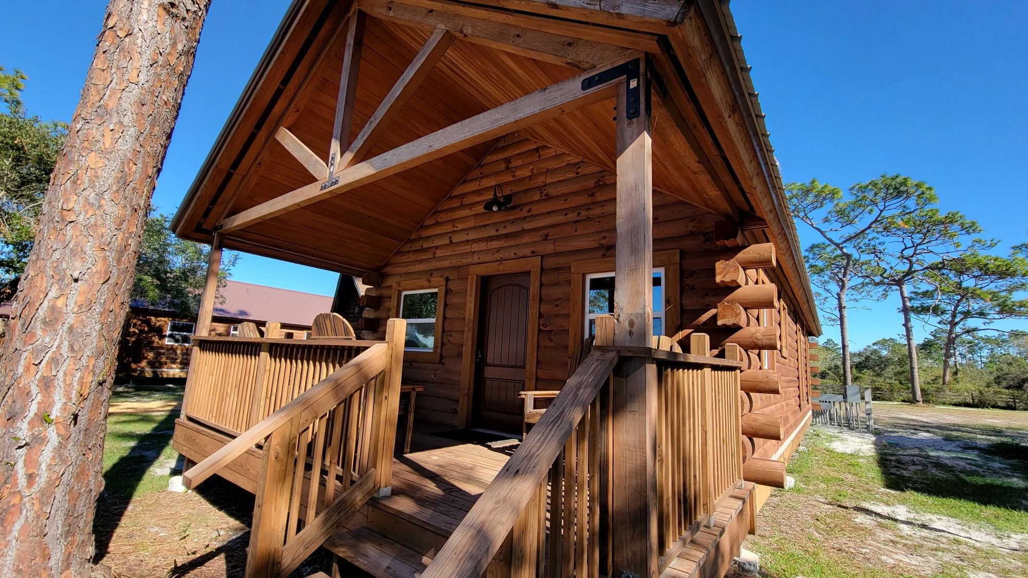 Charming modern cabins at central florida christian camp rental, families and youth arriving, unloading luggage, surrounded by oak trees