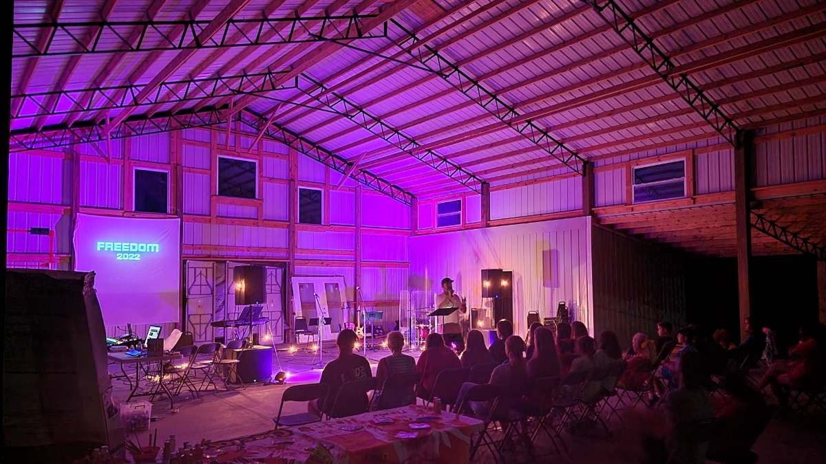 Multigenerational families and youth engaging in team-building activities at Camp Impact, collaborative bonding and laughter, ideal church camp and retreat for all ages in Central Florida