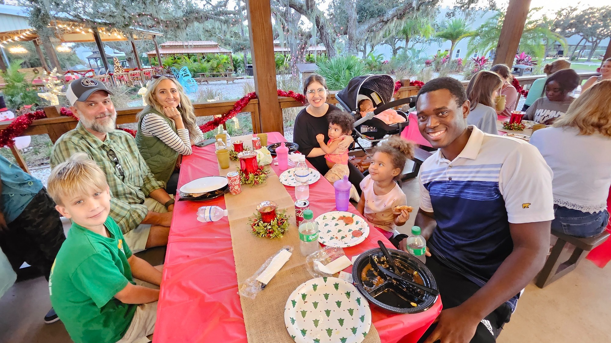 Group prayer circle outdoors at Christian camp in Florida, lakeside, oak trees, spiritual connection and happiness, soft natural sunlight