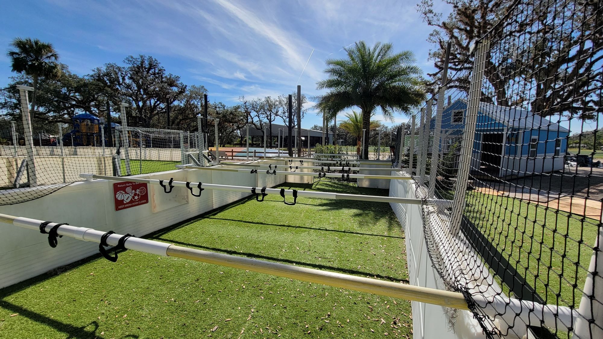 Large youth group playing soccer on a professional-grade field at Camp Impact, energetic outdoor activities in Central Florida, dynamic church camp sports facilities