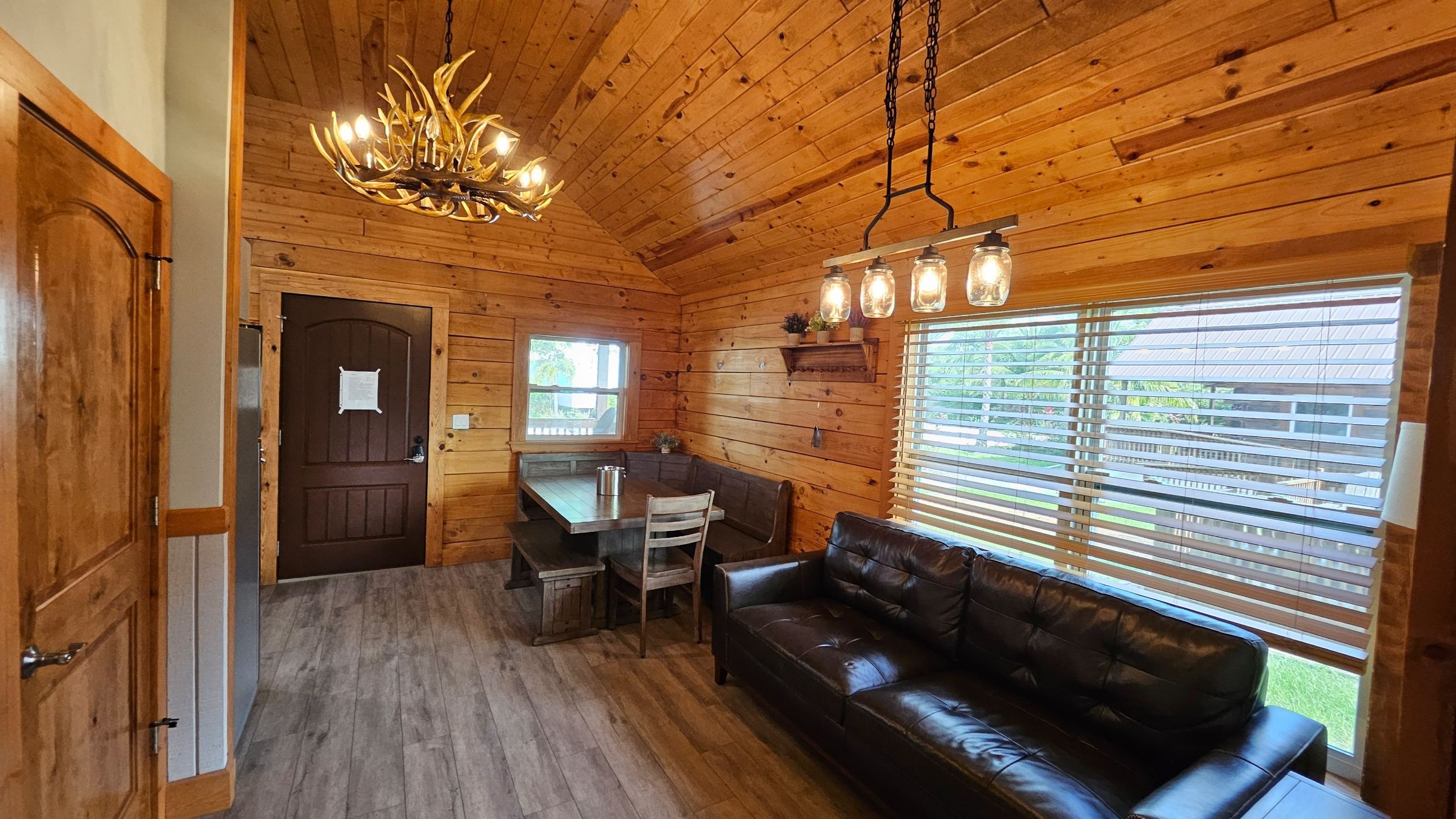 Modern cabin at a Christian camp in Florida, air-conditioned, families gathering with anticipation and contentment, pine backdrop, fresh morning atmosphere