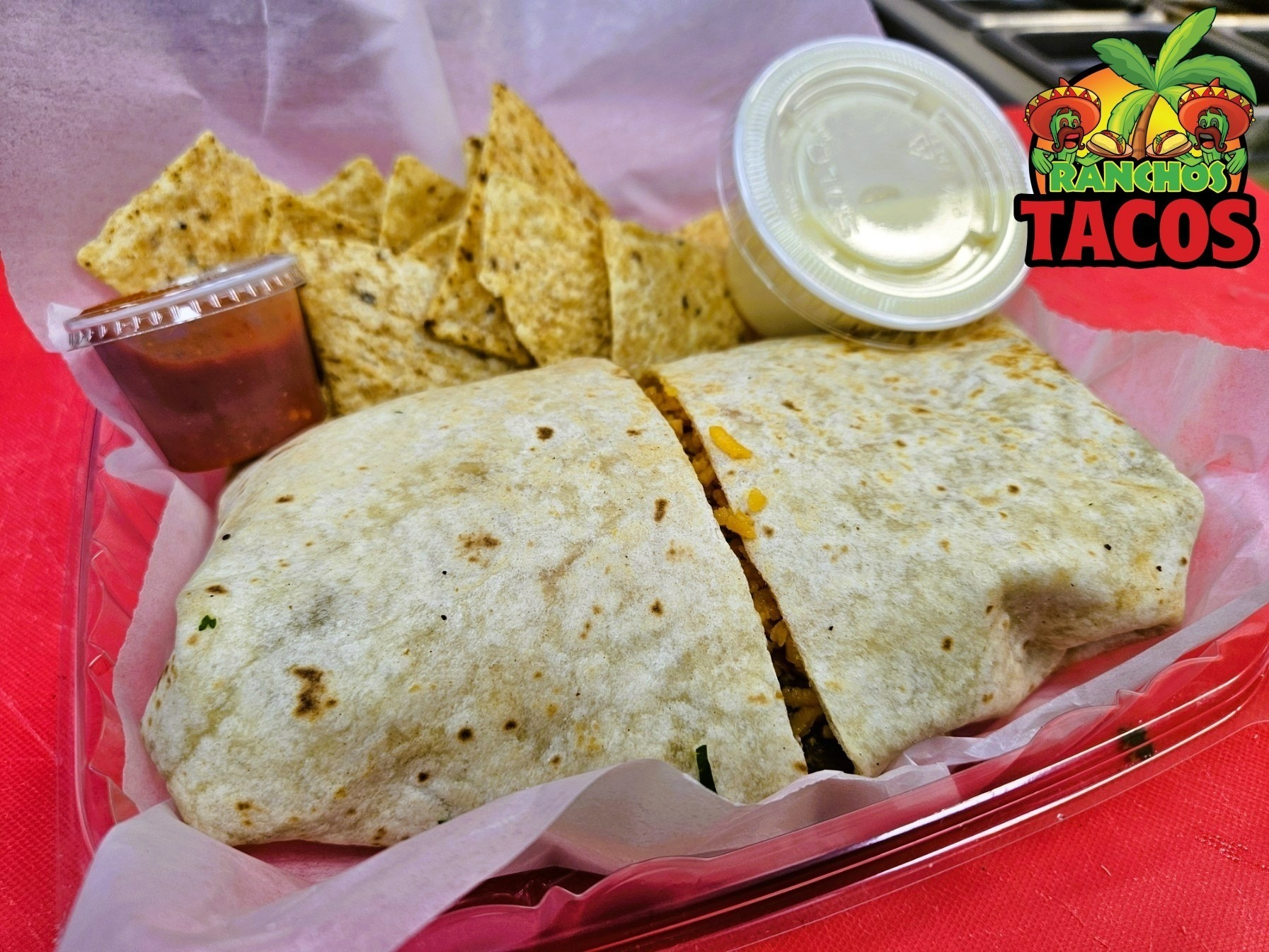 burrito with red sauce and sour cream at ranchos tacos in amherst new york