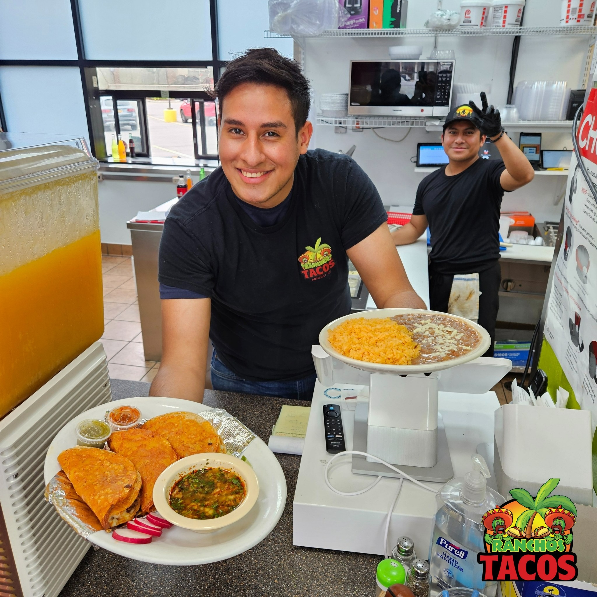 serving birria tacos with consome, rice and beans at ranchos tacos in amherst new york