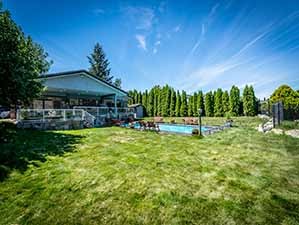 Kamloops waterfront for sale backyard looking back at house