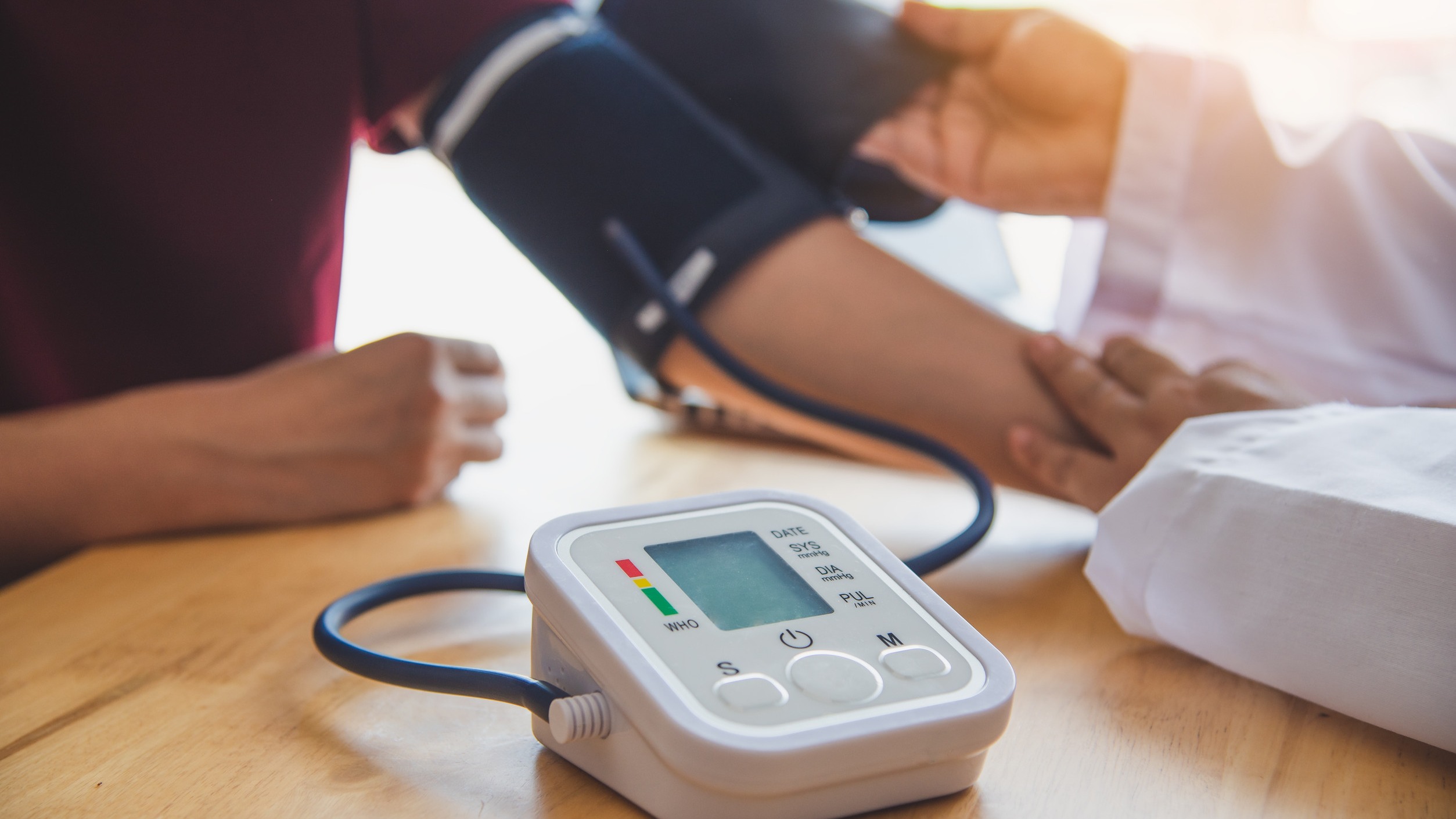 Doctor measuring blood pressure for Baxdrostat Hypertension Treatment.