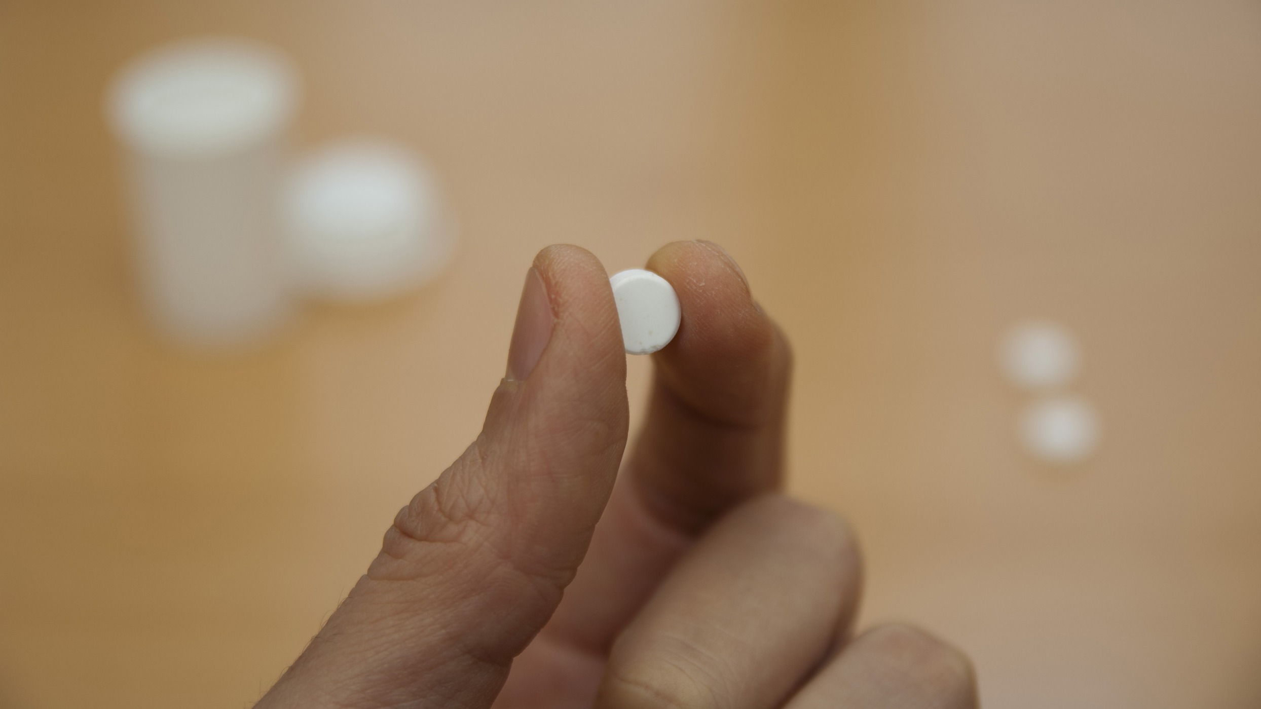 Close-up of Renue NMN anti-aging supplements bottle, emphasizing health lifestyle.