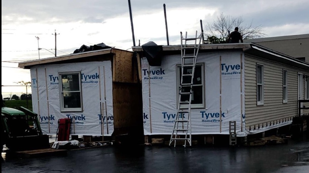Modular home sales lot featuring modern designs in natural daylight.