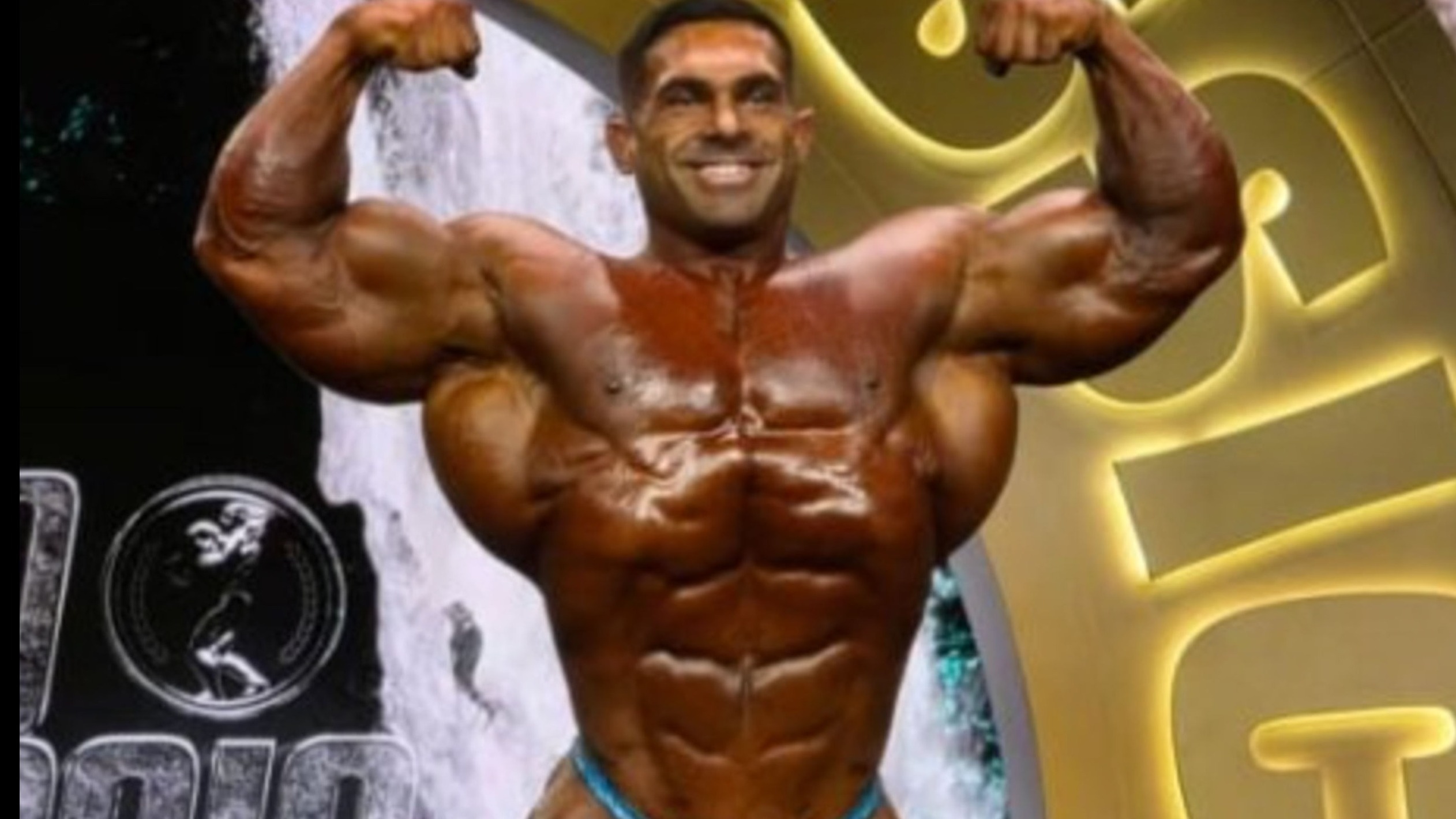 Bodybuilders competing on stage, strong physiques displayed.