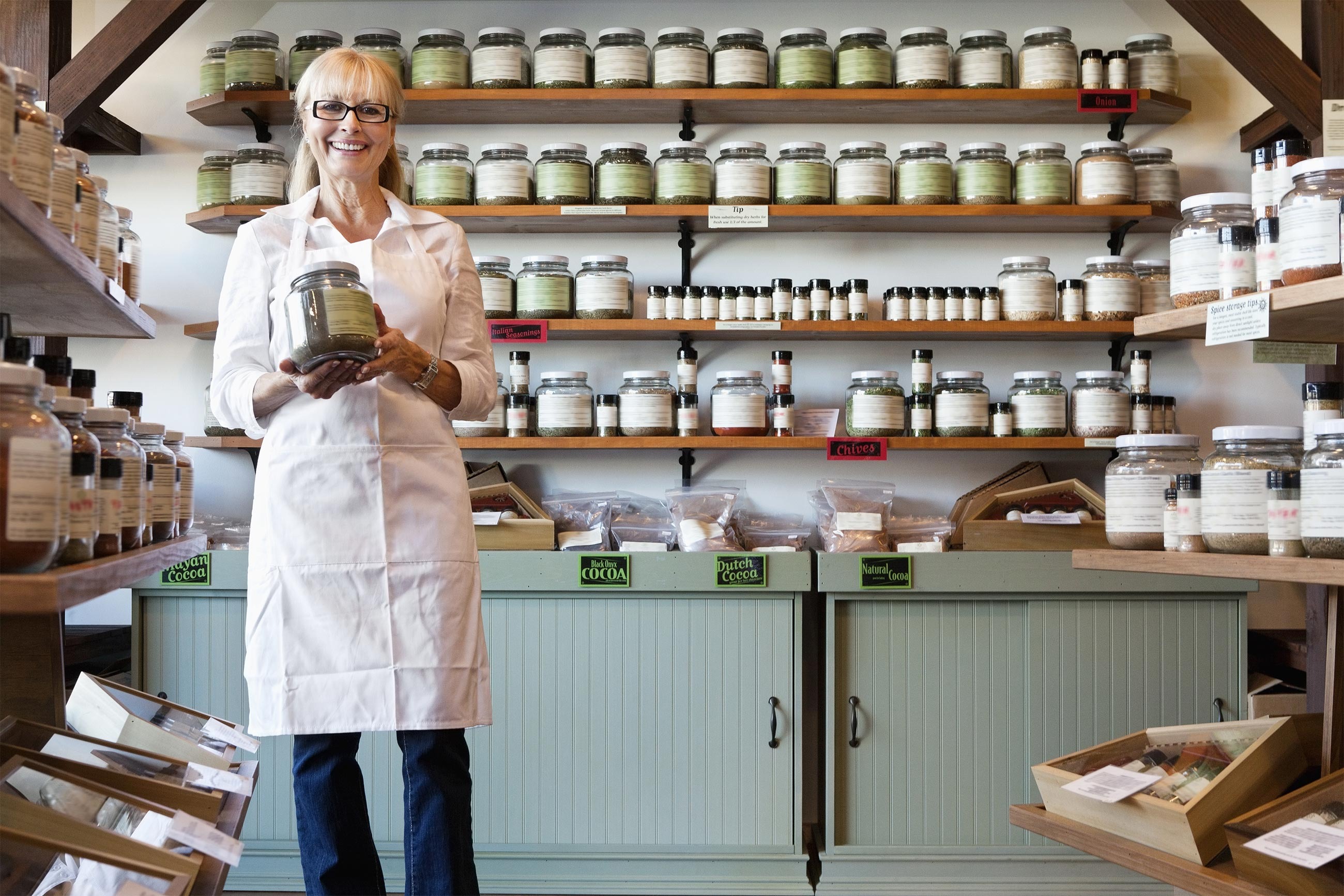 Female shop owner holding jar