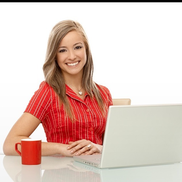 smiling female red top sitting behind laptop