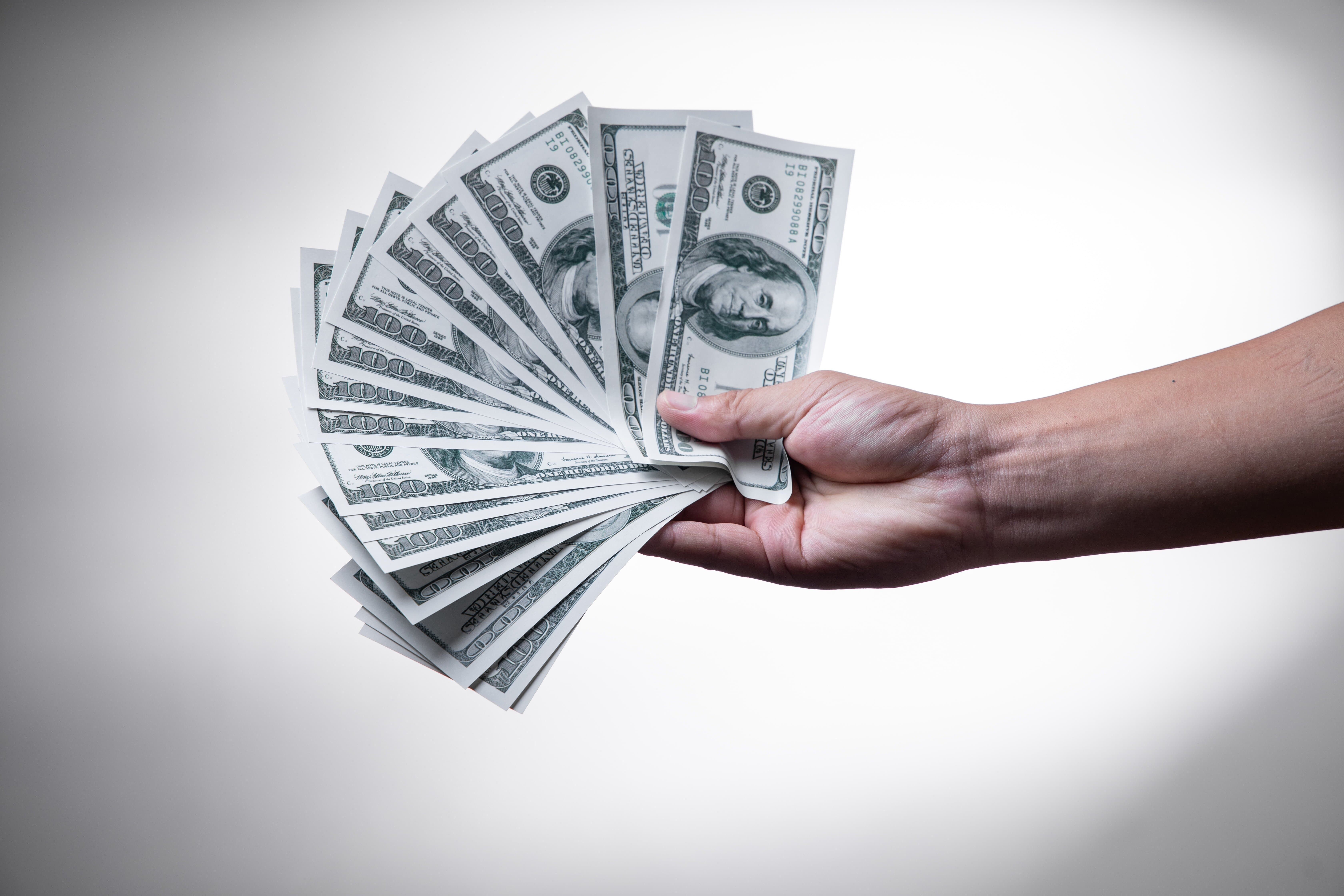 fanned out cash in hand