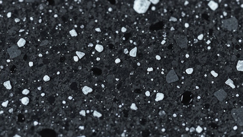 Macro shot of Midnight Granite epoxy with charcoal and white flecks texture.