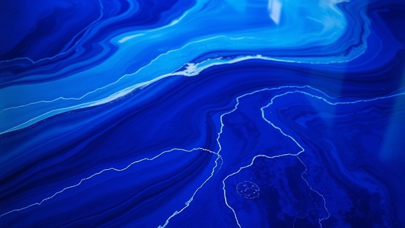 Stunning cobalt wave epoxy floor in electric blue over a midnight base.