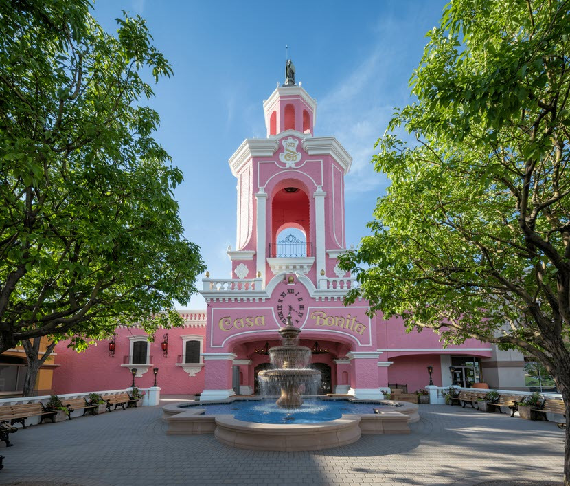 Lively Casa Bonita dining experience with vibrant pink building.