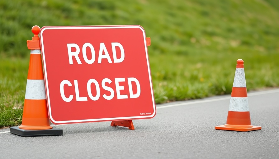 Monmouthshire road closure sign with traffic cones for water leak repairs.