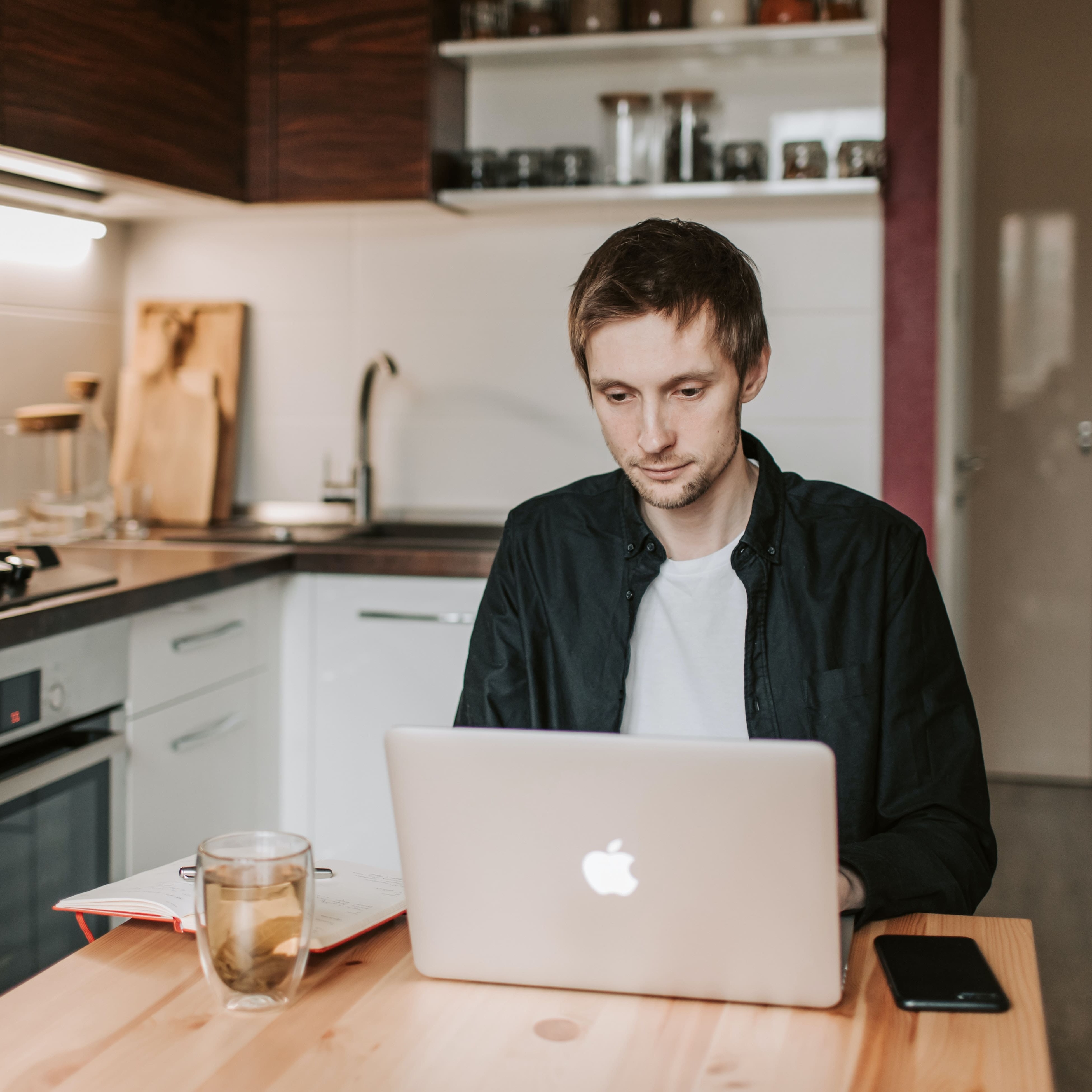 A coach sitting at the laptop