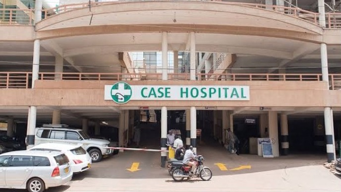 Modern Ugandan hospital exterior, bustling with activity, landscaped gardens, Case Clinic Medcare Uganda