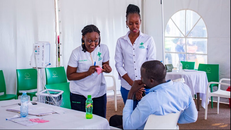 Case Clinics Uganda presentation with clinician in a medical tent setting.