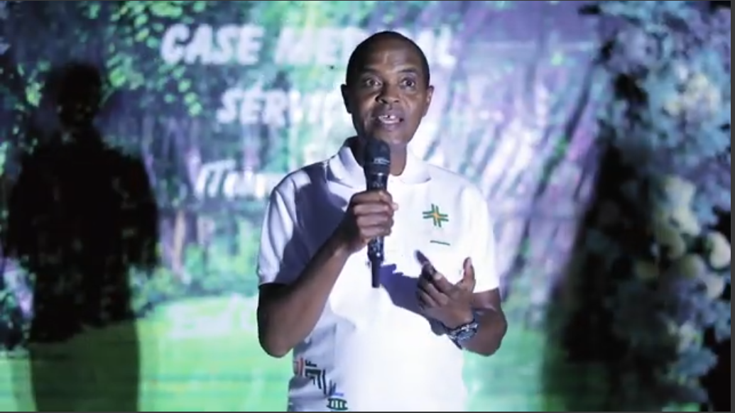 Joyful African medical professionals in white polos, promoting community health outdoors.